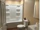 Bathroom showcasing a tiled shower, a toilet, and white cabinets at 501 W Taylor St, Alexandria, IN 46001