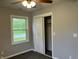 Bedroom with gray walls, window with view, ceiling fan, and open closet at 501 W Taylor St, Alexandria, IN 46001