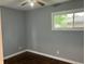 Bedroom with dark wood floors, neutral walls, ceiling fan, and a window at 501 W Taylor St, Alexandria, IN 46001