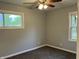 Bedroom featuring a ceiling fan, two windows with pleasant outdoor views, and neutral walls at 501 W Taylor St, Alexandria, IN 46001