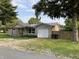 Charming single-story home with vinyl siding, metal roof and attached one car garage at 501 W Taylor St, Alexandria, IN 46001