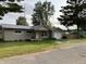 Charming single-story home with vinyl siding, metal roof and attached one car garage at 501 W Taylor St, Alexandria, IN 46001