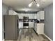 Bright kitchen featuring stainless steel appliances, white cabinets, and modern lighting at 501 W Taylor St, Alexandria, IN 46001