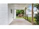 Open-air back porch with concrete flooring and white brick, perfect for relaxing and enjoying views of the backyard at 541 Dayton Ave, Indianapolis, IN 46203
