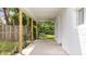 Comfortable back porch with natural wood supports, offering a peaceful outdoor retreat and view of the lush backyard at 541 Dayton Ave, Indianapolis, IN 46203