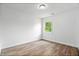 This bedroom is bright, featuring neutral colors, wood-look floors and a window at 541 Dayton Ave, Indianapolis, IN 46203