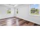 Sunny bedroom featuring stylish wood-look flooring and large windows, creating a bright and inviting space at 541 Dayton Ave, Indianapolis, IN 46203