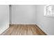 This bedroom is bright, featuring neutral colors, wood-look floors and a window at 541 Dayton Ave, Indianapolis, IN 46203