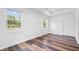 Bright bedroom with hardwood floors and large windows providing ample natural light with views of the neighborhood at 541 Dayton Ave, Indianapolis, IN 46203