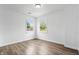 This bedroom is bright, featuring neutral colors, wood-look floors and two windows at 541 Dayton Ave, Indianapolis, IN 46203