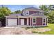 Beautiful two-story home featuring white trim, vertical siding, garage, and a well-manicured lawn at 541 Dayton Ave, Indianapolis, IN 46203
