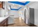 Modern kitchen with stainless steel appliances and a breakfast bar that opens to a brightly lit living space at 541 Dayton Ave, Indianapolis, IN 46203