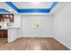 Spacious living area with hardwood floors and a partial view of the kitchen, illuminated by natural light from large windows at 541 Dayton Ave, Indianapolis, IN 46203
