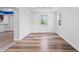 Bright living room with hardwood floors, fresh white paint, and large windows offering views of the landscaped outdoors at 541 Dayton Ave, Indianapolis, IN 46203