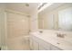 Well-lit bathroom with double sinks, a shower, and a large mirror at 5883 Sandalwood Dr, Carmel, IN 46033