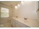 Bathroom featuring double sinks, a large vanity, and a window at 5883 Sandalwood Dr, Carmel, IN 46033