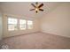 Bright bedroom with vaulted ceiling, ceiling fan, and large windows at 5883 Sandalwood Dr, Carmel, IN 46033