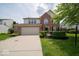 Charming two-story home with a two-car garage and well-maintained landscaping at 5883 Sandalwood Dr, Carmel, IN 46033