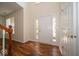 Bright foyer with hardwood floors, a white front door, and a view of the staircase at 5883 Sandalwood Dr, Carmel, IN 46033