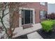 Elegant front door with sidelights, framed by brick and lush landscaping at 5883 Sandalwood Dr, Carmel, IN 46033