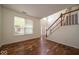 Inviting living room with hardwood floors, staircase, and abundant natural light at 5883 Sandalwood Dr, Carmel, IN 46033
