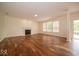 Spacious living room featuring a fireplace, hardwood floors, and large windows at 5883 Sandalwood Dr, Carmel, IN 46033