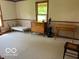 Bedroom with hardwood floors, twin bed, wooden dresser, and accent table at 622 S Washington St, Morristown, IN 46161