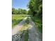 Gravel driveway leading through picturesque greenery, offering a sense of seclusion at 622 S Washington St, Morristown, IN 46161
