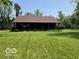Charming cabin with a full-length front porch, nestled in a tranquil, grassy setting at 622 S Washington St, Morristown, IN 46161