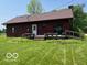 Exterior of home with a large, green lawn and wooden deck at 622 S Washington St, Morristown, IN 46161