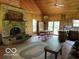 Inviting living room featuring a stone fireplace, wood accents, and a dining area at 622 S Washington St, Morristown, IN 46161