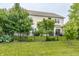 Well-manicured backyard with lush grass, wrought iron fence and partial home view at 6296 Sugar Maple Dr, Zionsville, IN 46077