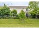 Spacious backyard featuring a lush green lawn, black fence, and home exterior at 6296 Sugar Maple Dr, Zionsville, IN 46077