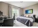 Comfortable bedroom with a bed, a desk and a bright window at 6296 Sugar Maple Dr, Zionsville, IN 46077