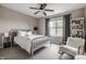 Comfortable bedroom featuring a metal frame bed, soft chair and bright window at 6296 Sugar Maple Dr, Zionsville, IN 46077
