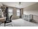 Bright bedroom featuring a modern desk, chair, and a crib beneath a ceiling fan at 6296 Sugar Maple Dr, Zionsville, IN 46077
