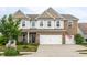 Charming two-story home with a well-manicured lawn and a two-car garage at 6296 Sugar Maple Dr, Zionsville, IN 46077
