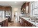 Bright kitchen featuring granite countertops, stainless steel appliances, and wood flooring at 6296 Sugar Maple Dr, Zionsville, IN 46077