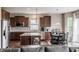 Modern kitchen with stainless steel appliances, granite countertops, and dark wood cabinetry at 6296 Sugar Maple Dr, Zionsville, IN 46077