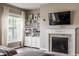 Bright living room featuring a cozy fireplace, built-in shelves, and large windows at 6296 Sugar Maple Dr, Zionsville, IN 46077