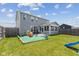 Exterior view of home featuring a gray siding, screened-in porch, large lawn, and a play area at 632 Albermarle Dr, Pittsboro, IN 46167