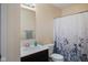 Full bathroom with floral shower curtain, single vanity, and a standard toilet at 632 Albermarle Dr, Pittsboro, IN 46167