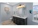 Stylish bathroom with double sinks, modern lighting, and walk-in shower at 632 Albermarle Dr, Pittsboro, IN 46167