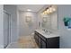 Bright bathroom features double sinks, modern lighting, and a walk-in shower at 632 Albermarle Dr, Pittsboro, IN 46167