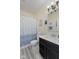 Bathroom with a vanity with sink, floral decorations and patterned shower curtain at 632 Albermarle Dr, Pittsboro, IN 46167