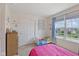 A sunny bedroom features a window with blue curtains and kid themed decorations at 632 Albermarle Dr, Pittsboro, IN 46167