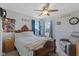 Comfortable bedroom with ceiling fan, cozy armchair, and natural light at 632 Albermarle Dr, Pittsboro, IN 46167
