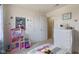 Bright bedroom featuring plush carpet, closet, and a cute dollhouse at 632 Albermarle Dr, Pittsboro, IN 46167