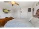 Charming bedroom with ceiling fan, TV, dresser, and light patterned bedding at 632 Albermarle Dr, Pittsboro, IN 46167