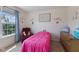 Cozy bedroom with pink bedding, plush carpeting and a comfortable recliner at 632 Albermarle Dr, Pittsboro, IN 46167
